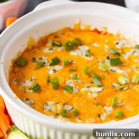 Buffalo Chicken Dip - A creamy, cheesy, and spicy dip perfect for game day or parties. Made with chicken, ranch, buffalo sauce, and multiple cheeses for a flavor explosion.