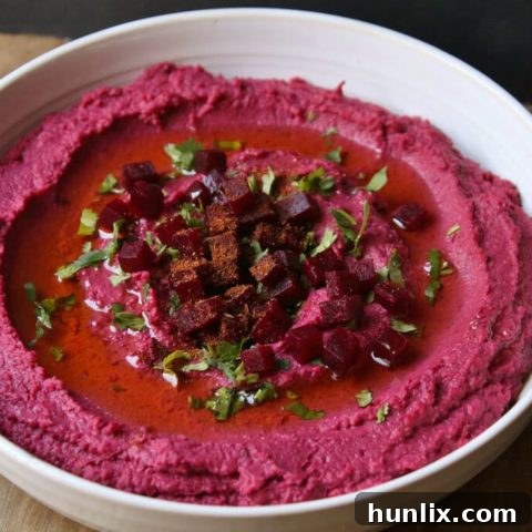 Baharat Roasted Beet Hummus - A flavorful, vegan, and gluten-free snack made with common ingredients and Baharat spice blend. Easily adjustable with your favorite spices.