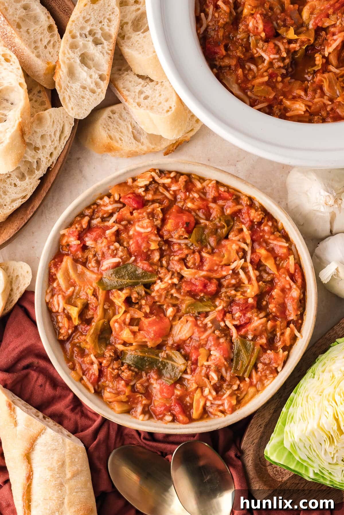 A beautifully presented bowl of Cabbage Roll Soup, garnished with a swirl of sour cream and fresh herbs, ready for serving.
