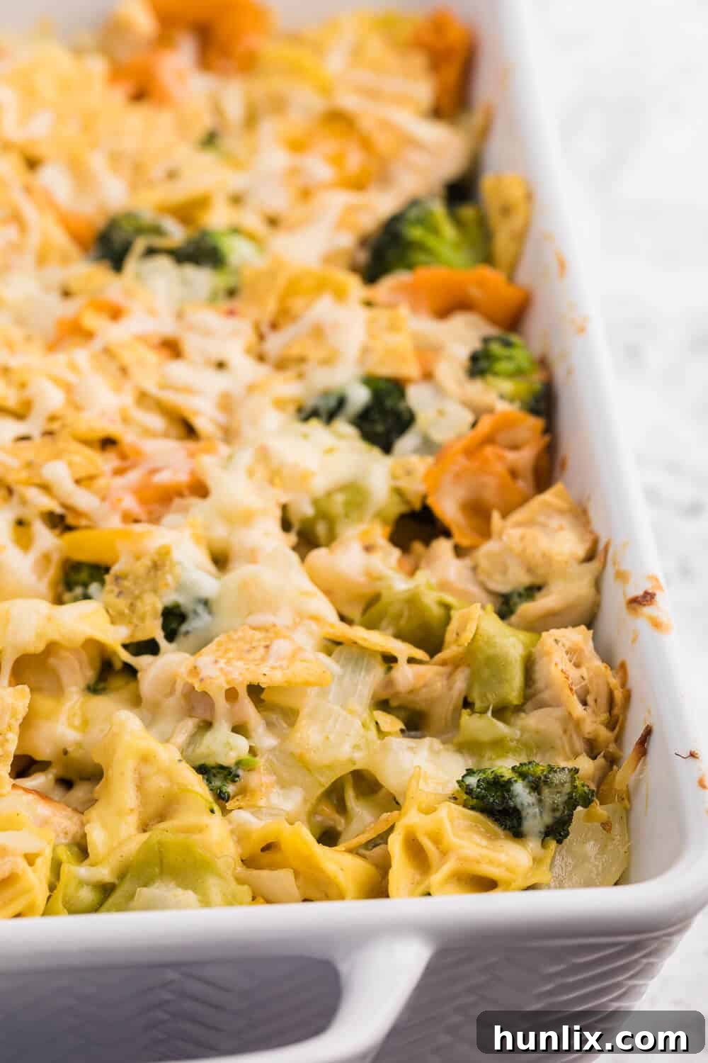 Delicious Santa Fe Chicken Tortellini Casserole, garnished with fresh cilantro and lime wedges.