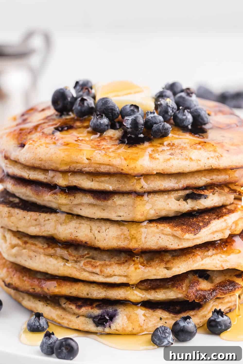 Fluffy Whole Wheat Blueberry Morning Cakes 3 Close-up of fluffy whole wheat blueberry pancakes on a plate with syrup