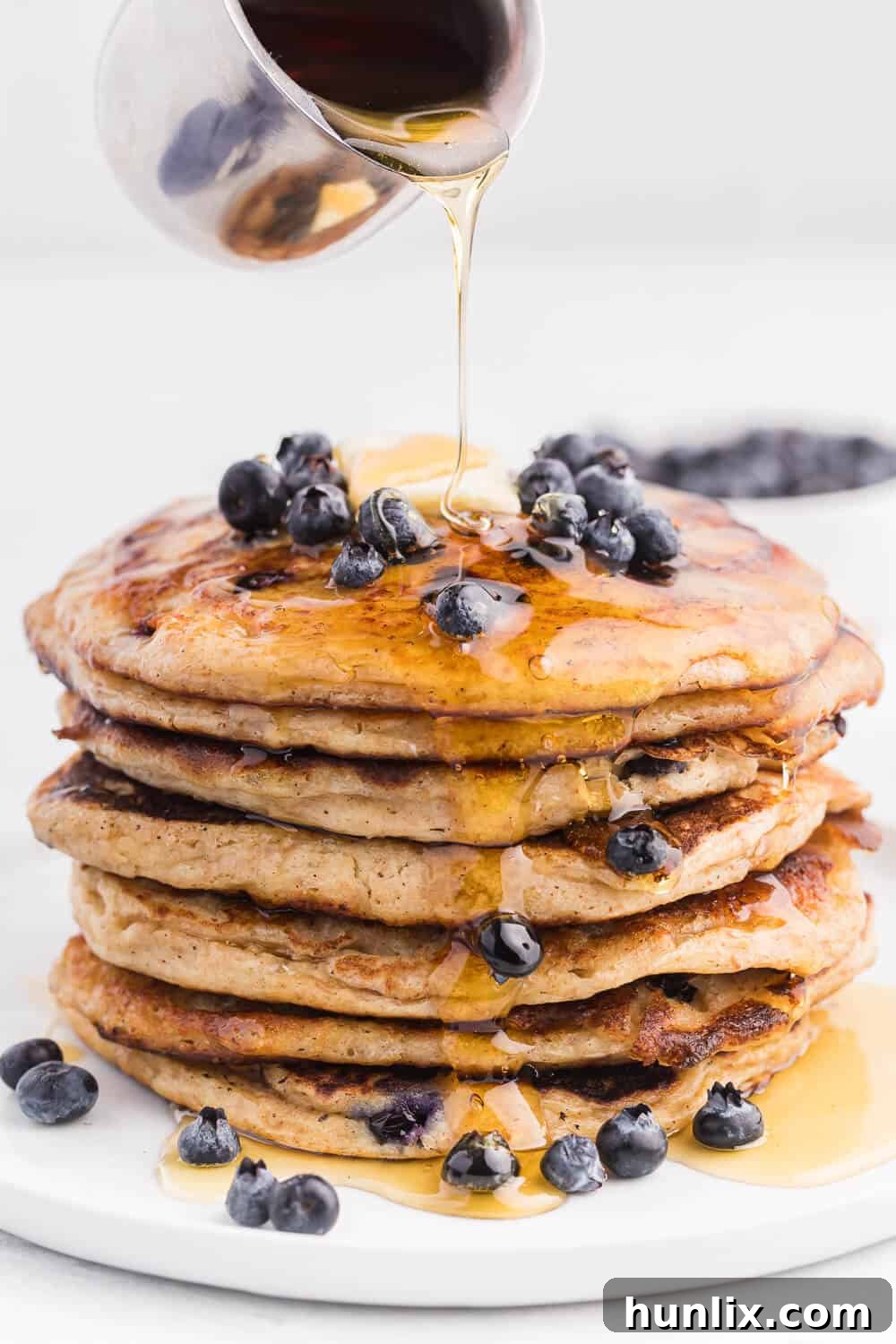Fluffy Whole Wheat Blueberry Morning Cakes 5 Stack of freshly cooked whole wheat blueberry pancakes topped with berries