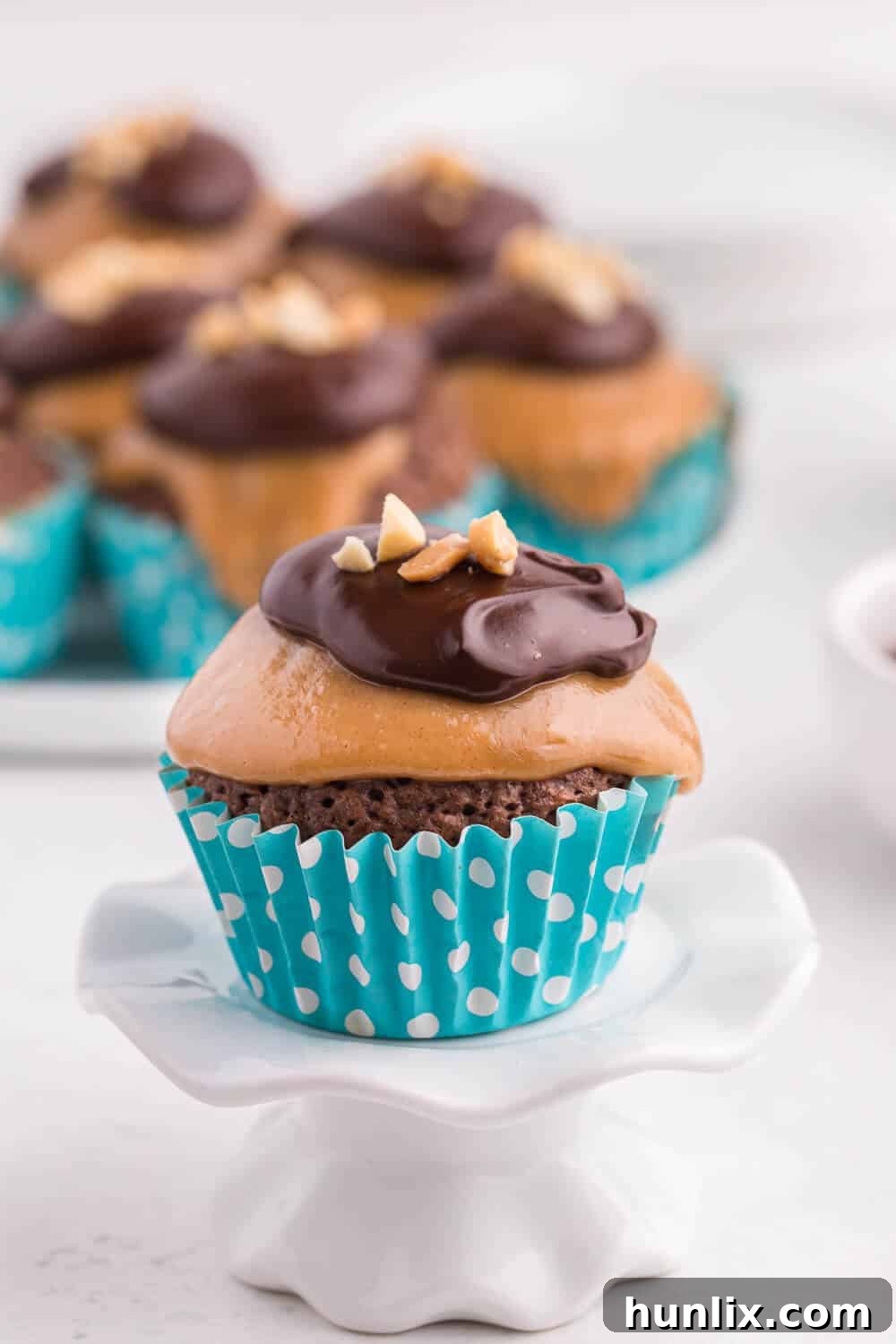 Peanut Butter Brownie Bliss 5 A display of peanut butter brownie cupcakes on a cupcake stand.