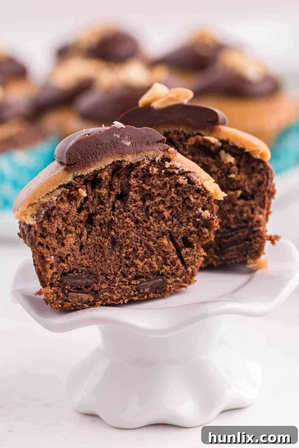 Peanut Butter Brownie Bliss 6 A cut peanut butter brownie cupcake showing its distinct layers.