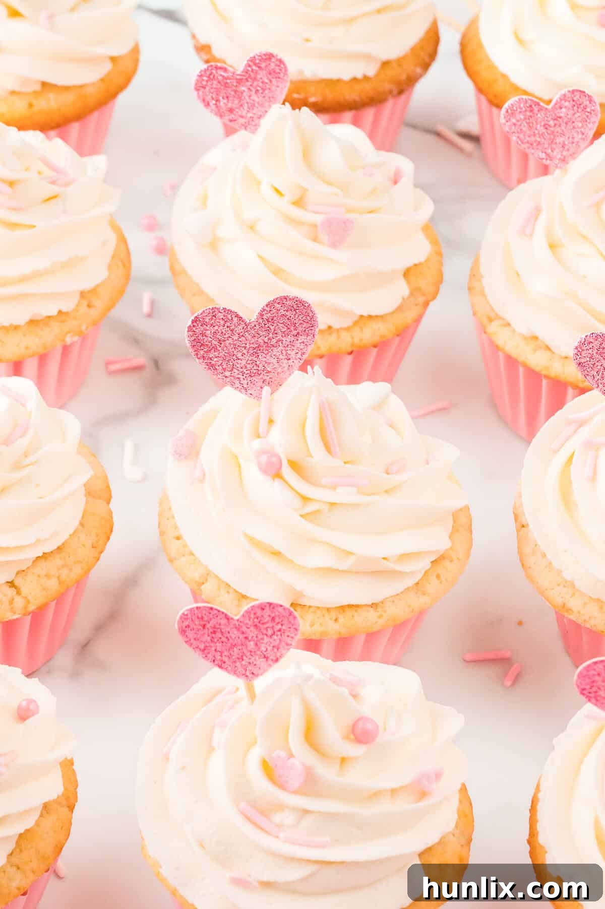 A charming group of Valentine's Day cupcakes, beautifully frosted and decorated, arranged for a festive display.