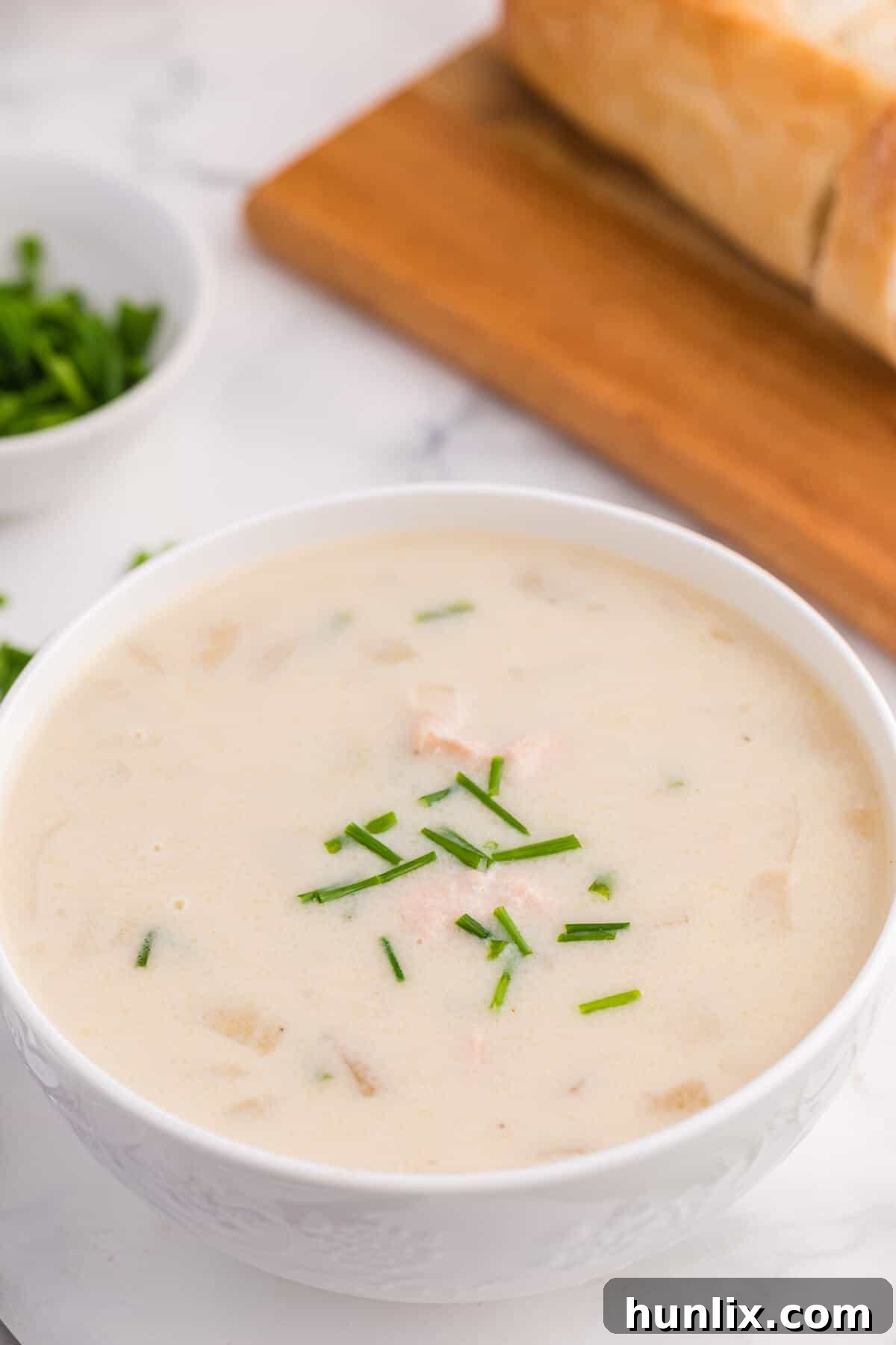 Salmon chowder in a white bowl.