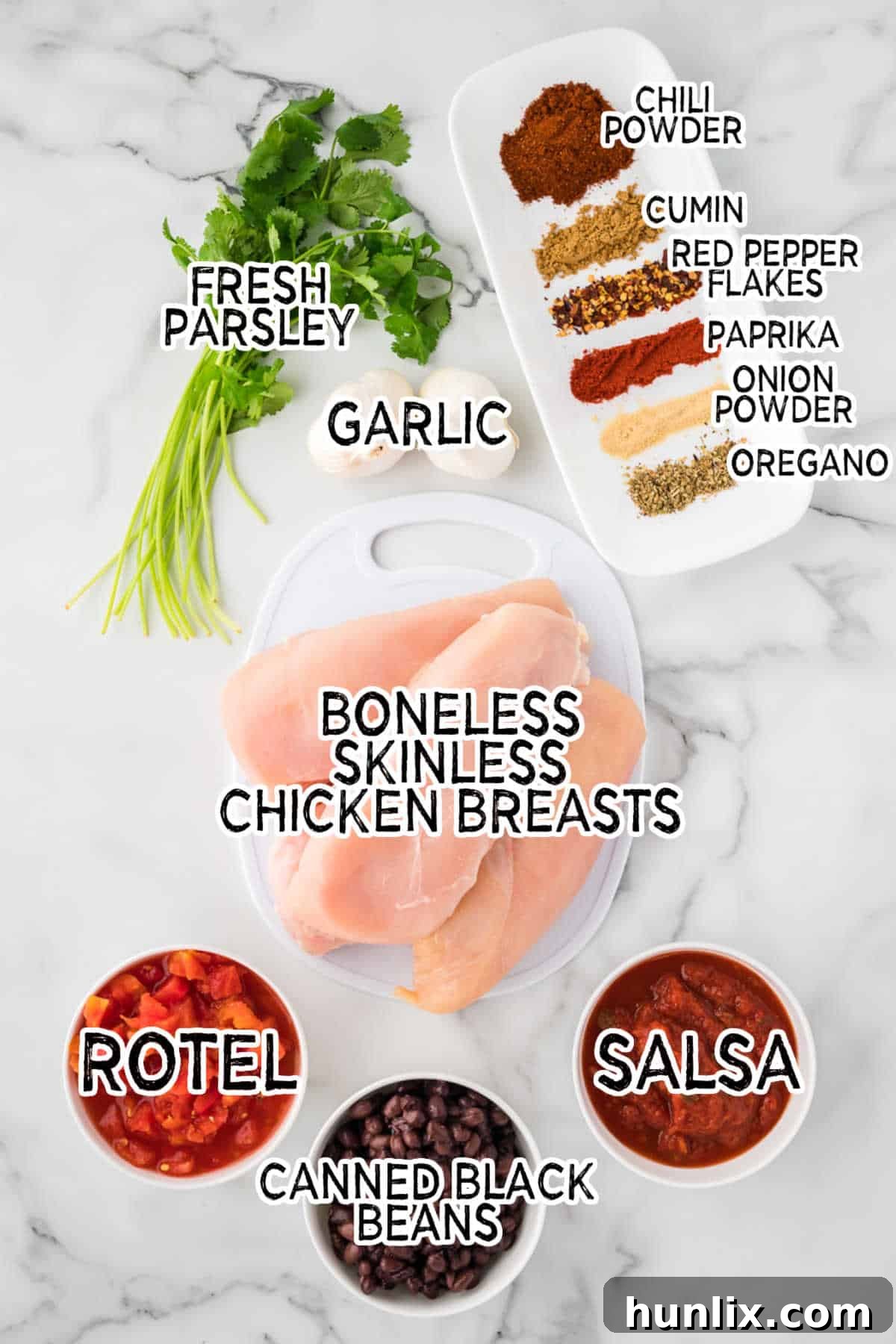 A vibrant flat lay of all the fresh ingredients needed for Slow Cooker Salsa Chicken on a marble counter.