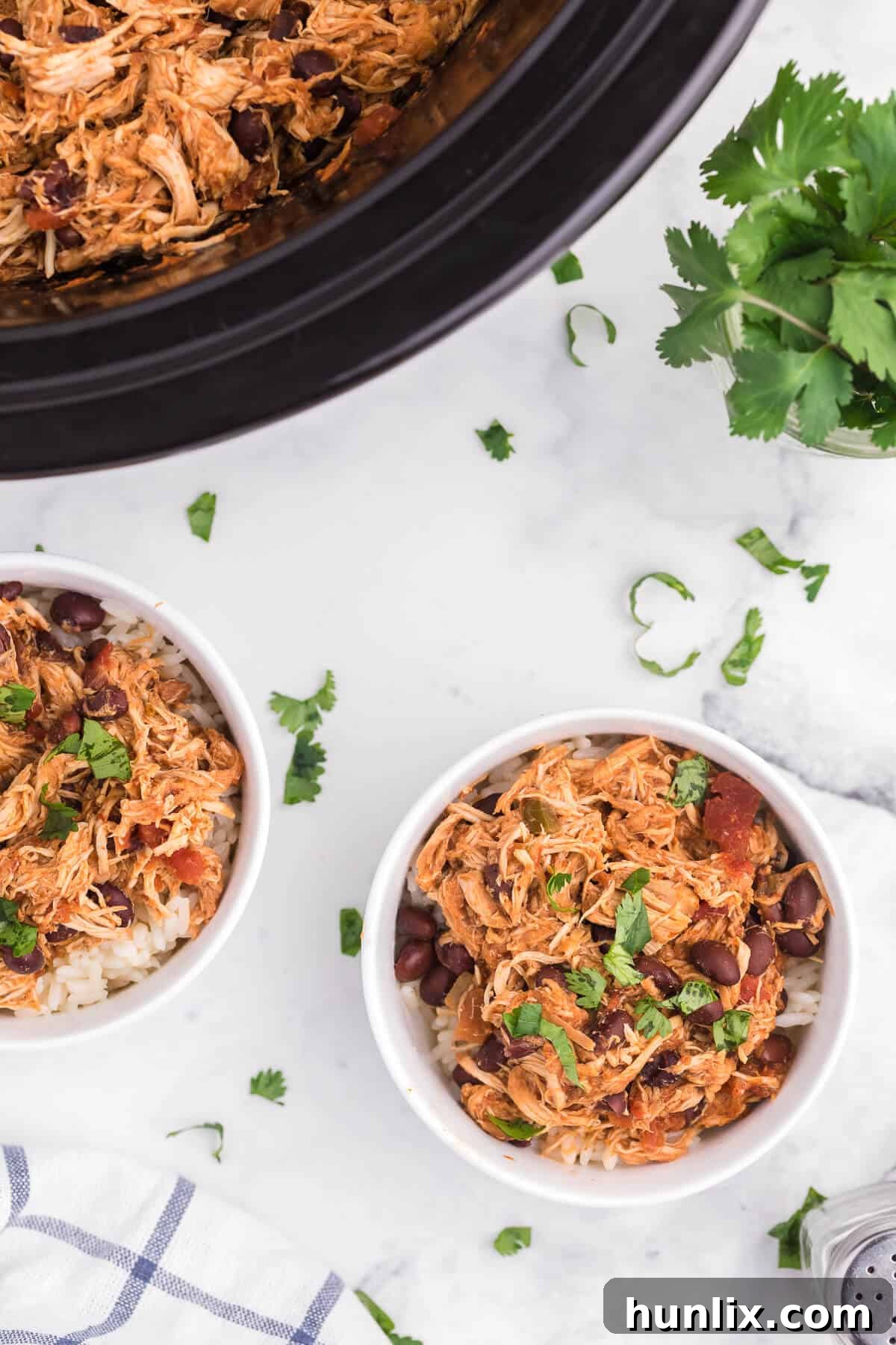 Multiple bowls of Slow Cooker Salsa Chicken, garnished and ready to be served, showcasing its versatility.
