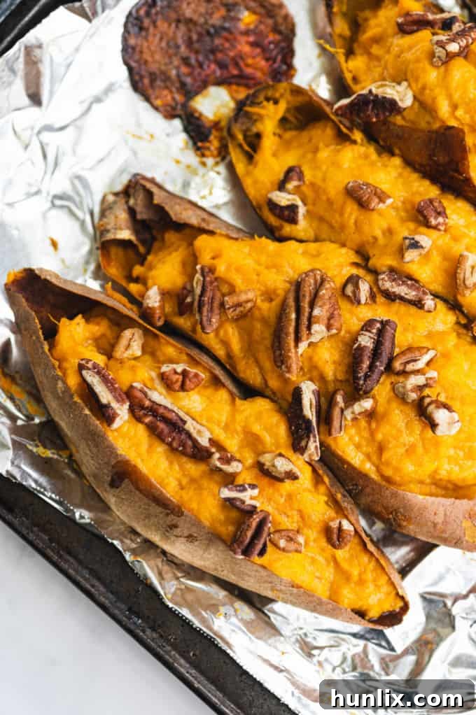 Twice Baked Sweet Potatoes with creamy filling, topped with pecans, a delightful blend of sweet and savory.