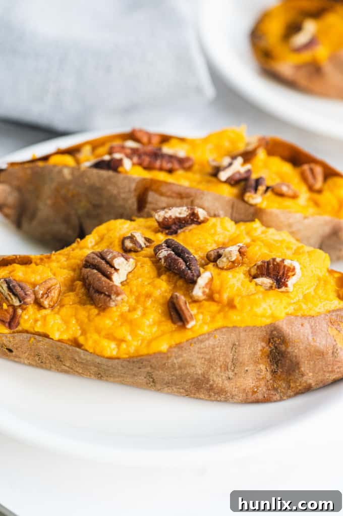 A close-up of a Twice Baked Sweet Potato, showing the creamy filling and toasted pecans.