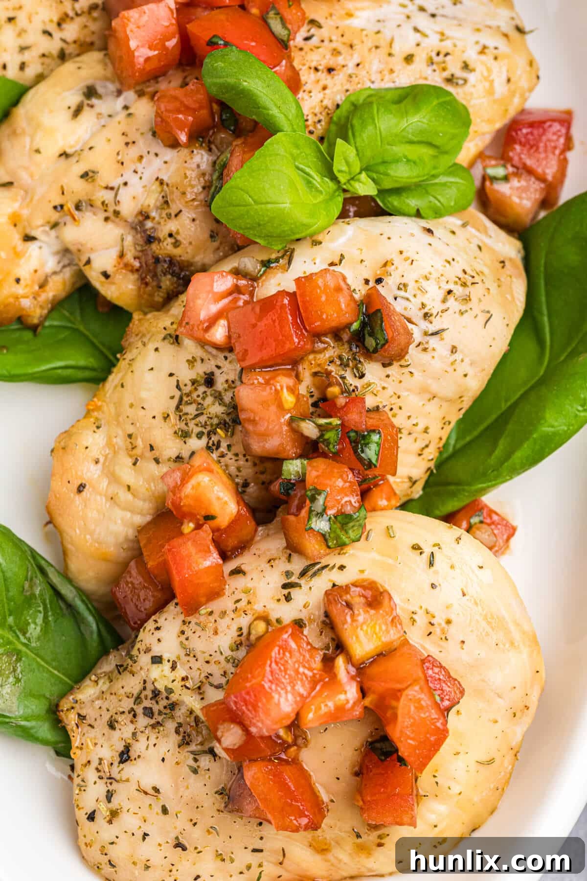 Platter of Bruschetta Chicken ready to be served, showcasing the vibrant tomato and basil topping.