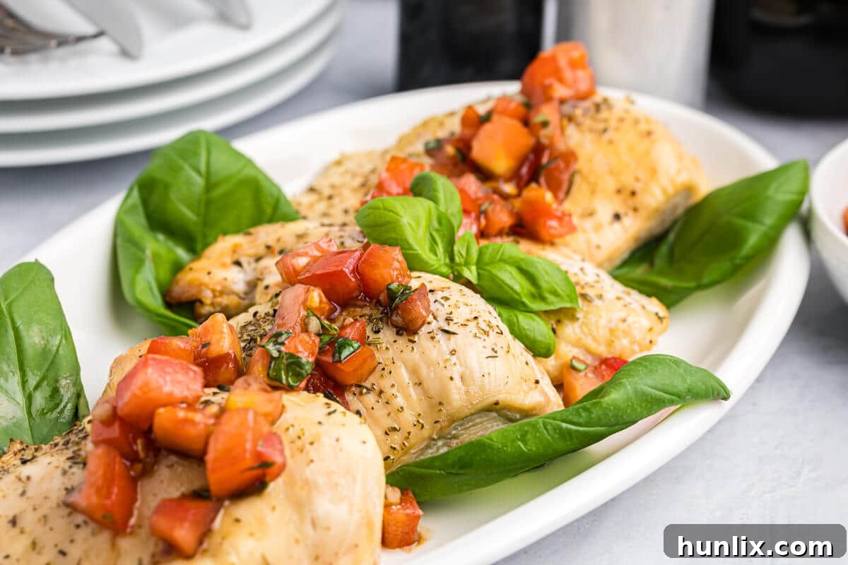 Close-up of Bruschetta Chicken on a platter, showcasing the texture and freshness.