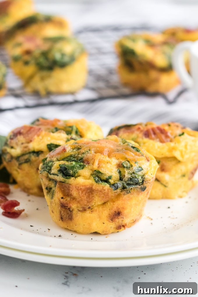 A plate featuring several spinach and cheese egg muffins, ready for serving as a delicious and healthy breakfast.