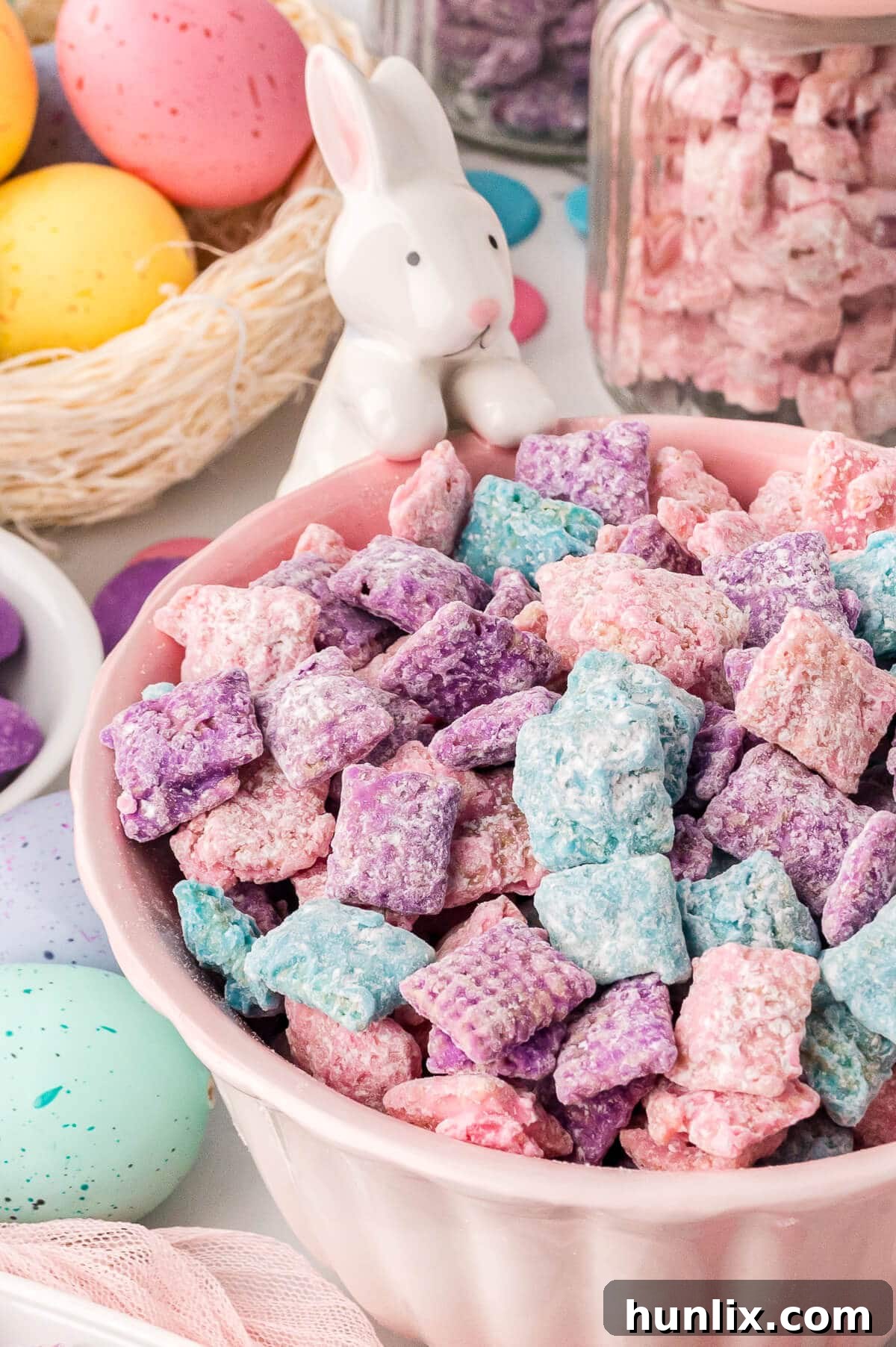 A close-up of Easter Puppy Chow in a pink bowl.