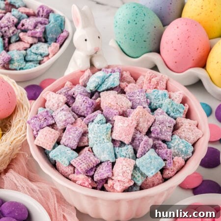 The Easter Puppy Chow recipe presented in a vibrant pink bowl.